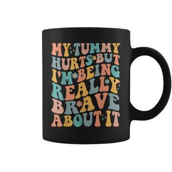 My Tummy Hurts But Im Being Really Brave About It Groovy IT Funny Gifts Coffee Mug | Mazezy