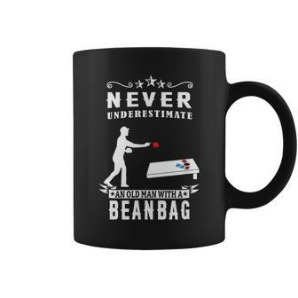 Never Underestimate An Old Man With A Bean Bag Cornhole Old Man Funny Gifts Coffee Mug | Mazezy