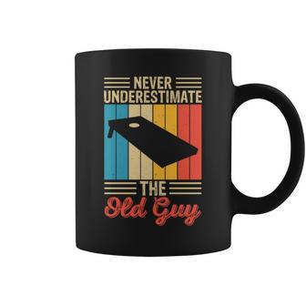 Never Underestimate The Old Guy Funny Cornhole Player Mens Coffee Mug - Seseable