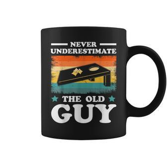 Never Underestimate The Old Guy Sack Toss Cornhole Coffee Mug | Mazezy