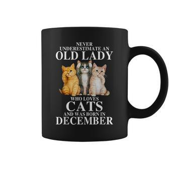 Never Underestimate An Old Lady Who Loves Cats Born December Coffee Mug | Mazezy