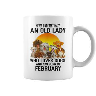 Never Underestimate An Old February Lady Who Loves Dogs Coffee Mug - Seseable
