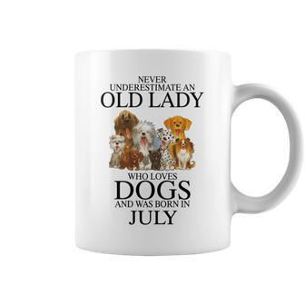 Never Underestimate An Old Lady Who Loves Dogs Born July Coffee Mug - Seseable