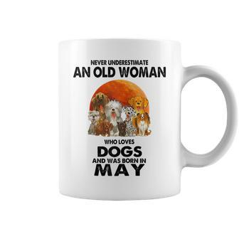 Never Underestimate An Old Woman Who Loves Dogs Born In May Coffee Mug - Seseable