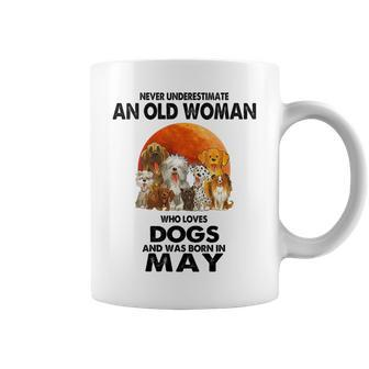 Never Underestimate An Old Woman Who Loves Dogs Born In May Gift For Womens Coffee Mug - Seseable
