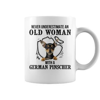Never Underestimate An Old Woman With A German Pinscher Old Woman Funny Gifts Coffee Mug | Mazezy