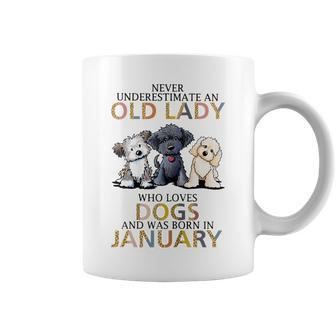 Never Underestimate Old Lady Loves Dogs Born In January Gift For Womens Coffee Mug - Seseable