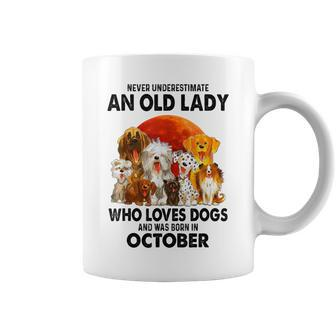 Never Underestimate An Old Lady Who Loves Dogs October Coffee Mug | Mazezy