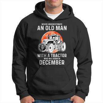 Never Underestimate An Old Man With A Tractor December Hoodie - Seseable