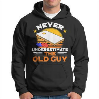 Never Underestimate The Old Guy I Funny Cornhole Gift For Mens Hoodie | Mazezy