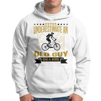 Never Underestimate An Old Guy On A Bicycle Cycling Lover Cycling Funny Gifts Hoodie | Mazezy