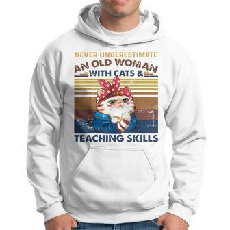 Never Underestimate An Old Woman With Cats & Teaching Skills Old Woman Funny Gifts Hoodie | Mazezy