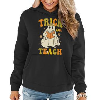 Trick Or Teach Groovy Halloween Retro Floral Ghost Teacher Women Hoodie - Monsterry