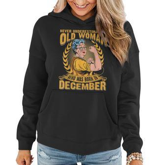 Never Underestimate An Old Woman Who Born In December Women Hoodie - Seseable