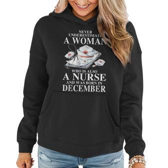 Never Underestimate A Woman Who Is Also A Nurse December Women Hoodie | Mazezy