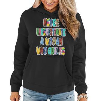 Never Underestimate A Woman Who Quilts Patchwork Letters Women Hoodie - Monsterry DE