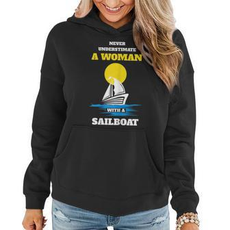 Never Underestimate A Woman With A Sailboat Women Hoodie - Seseable