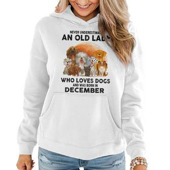 Never Underestimate Old Lady Loves Dogs Born In December Women Hoodie | Mazezy