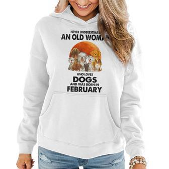 Never Underestimate An Old Woman Who Loves Dogs February Women Hoodie - Thegiftio UK