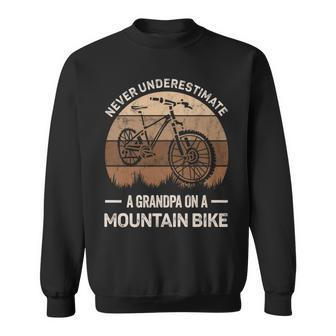 Never Underestimate A Grandpa On A Mountain Bike Bicycling Grandpa Funny Gifts Sweatshirt | Mazezy