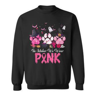 In October We Wear Pink Breast Cancer Halloween Dog Paws Sweatshirt - Monsterry DE