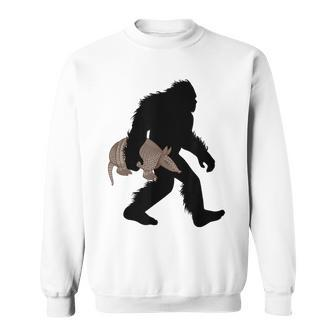 Bigfoot Cradling Armadillo Cryptid Sasquatch Sweatshirt | Mazezy