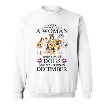 Never Underestimate A Woman Who Loves Dog Born In December Sweatshirt | Mazezy