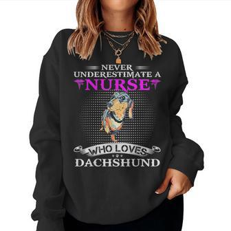 Never Underestimate A Nurse Who Loves Dachshund Dog Funny Women Crewneck Graphic Sweatshirt - Seseable