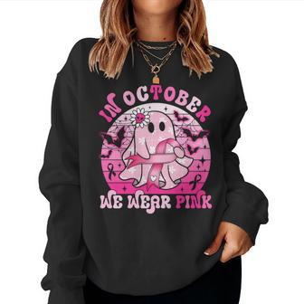 In October We Wear Pink Breast Cancer Groovy Ghost Halloween Women Sweatshirt - Seseable