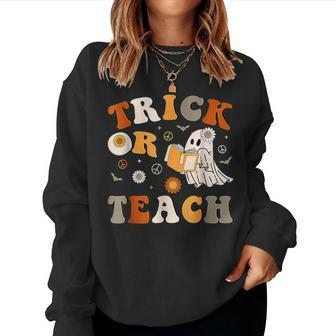 Trick Or Teach Groovy Halloween Retro Floral Ghost Teacher Women Sweatshirt | Mazezy