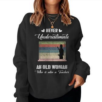 Never Underestimate An Old Woman Who Is A Teacher Women Sweatshirt | Mazezy