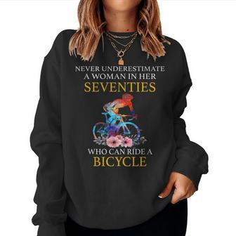 Never Underestimate Woman In Her Seventies Rides A Bicycle Women Sweatshirt - Seseable