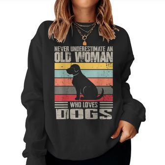 Vintage Never Underestimate An Old Woman Who Loves Dogs Cute Women Sweatshirt - Seseable