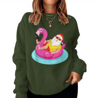 Christmas In July Santa Relaxing On A Flamingo Float Women Sweatshirt - Monsterry UK