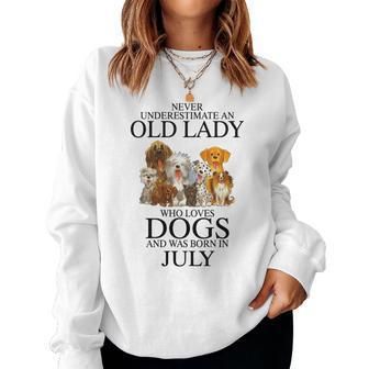 Never Underestimate An Old Lady Who Loves Dogs Born July Women Crewneck Graphic Sweatshirt - Seseable