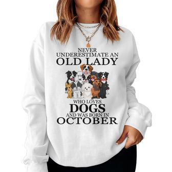 Never Underestimate An Old Lady Who Loves Dogs October Women Crewneck Graphic Sweatshirt - Seseable
