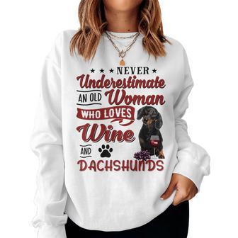 Never Underestimate An Old Woman Who Loves Wine & Dachshund Women Crewneck Graphic Sweatshirt - Seseable