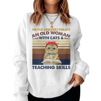 Never Underestimate An Old Woman With Cats & Teaching Skills Gift For Womens Women Crewneck Graphic Sweatshirt - Seseable