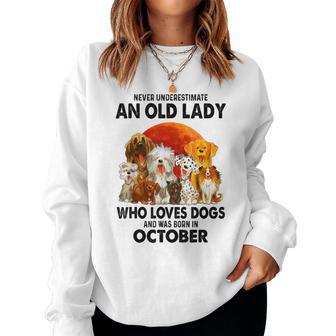 Never Underestimate An Old Lady Who Loves Dogs October Women Sweatshirt | Mazezy