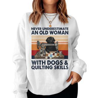 Never Underestimate An Old Woman With Dogs & Quilting Skills Women Sweatshirt | Mazezy