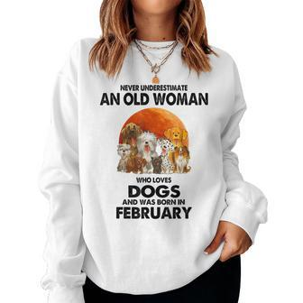 Never Underestimate An Old Woman Who Loves Dogs February Women Sweatshirt - Thegiftio UK