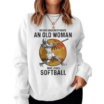 Never Underestimate An Old Woman Who Loves Softball Vintage Women Sweatshirt - Seseable