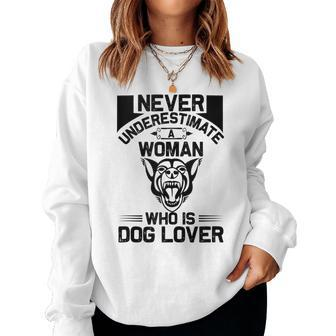 Never Underestimate A Woman Who Is A Dog Lover Dog Women Sweatshirt - Seseable
