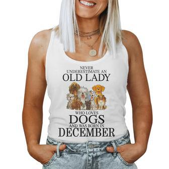 Never Underestimate An Old Lady Who Loves Dogs Born December Women Tank Top | Mazezy