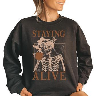 Staying Alive Skeleton Drink Coffee Funny Skull Halloween Women Oversized Sweatshirt | Mazezy