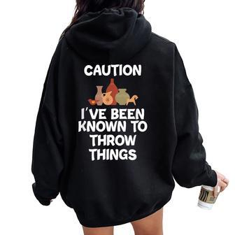 Caution I've Been Known To Throw Things Pottery Women Oversized Hoodie Back Print | Mazezy
