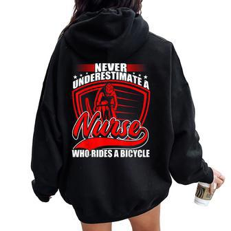 Never Underestimate A Nurse Who Rides A Bicycle Women Oversized Hoodie Back Print - Monsterry AU