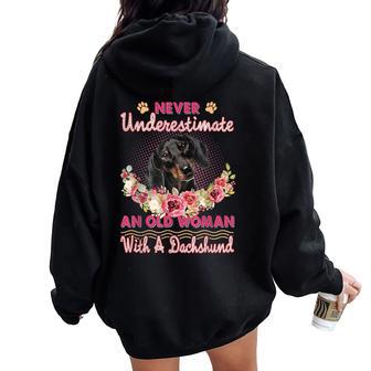 Never Underestimate An Old Woman With A Dachshund Dog Lovers Women Oversized Hoodie Back Print - Thegiftio UK