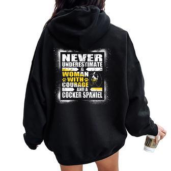 Never Underestimate Woman Courage And A Cocker Spaniel Women Oversized Hoodie Back Print - Monsterry