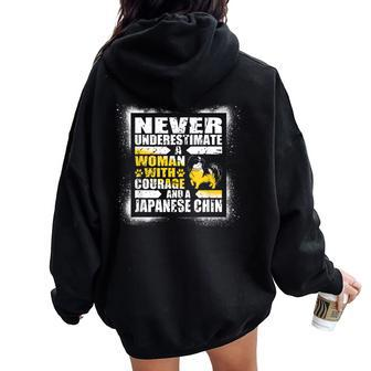 Never Underestimate Woman Courage And A Japanese Chin Women Oversized Hoodie Back Print - Monsterry